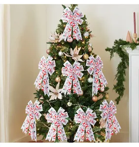 Detailed view of white double-layered Christmas tree bows featuring festive Santa patterns