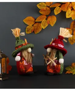 Pair of cute autumn harvest gnomes with fall leaf patterns and straw hats