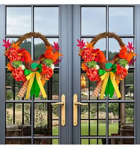 Detail view of two Thanksgiving wreaths with chicken dolls hanging on glass doors