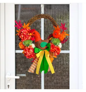 Detailed view of Thanksgiving door wreath with felt chicken, flowers and maple leaves.
