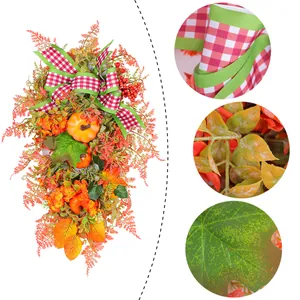 Guirlande d'automne artificielle avec citrouilles, baies rouges et nœud à carreaux.