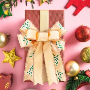 Decorative double-layered champagne gold Christmas bow on a gift box background
