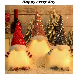 Set of glowing Christmas gnomes featuring sequined hats and warm LED light-up beards.
