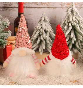 Detailed view of two sequined Christmas gnomes with fluffy beards for holiday decor.