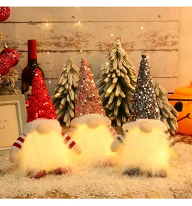 Detail of sequined Christmas gnomes with warm glowing LED lights and fluffy beards