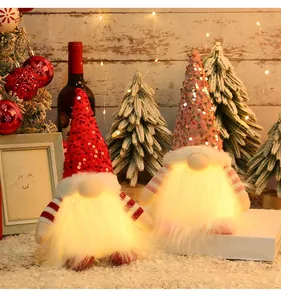Pair of lighted Christmas gnomes with sequined hats displayed in a festive home setting