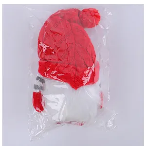 Detailed view of LED Christmas gnome with red knitted hat inside clear plastic packaging