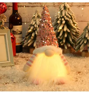 Detailed view of a handmade sequined Christmas gnome plush featuring warm glowing LED lights
