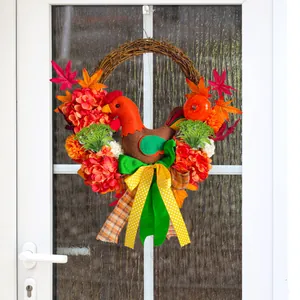 Thanksgiving grapevine wreath with plush rooster, hydrangea flowers and maple leaves.