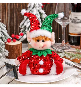 Detailed view of a sequined Christmas elf plush sitting on a white display plate