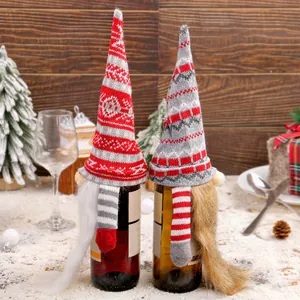Pair of knitted Christmas gnome wine bottle covers for festive holiday table decoration
