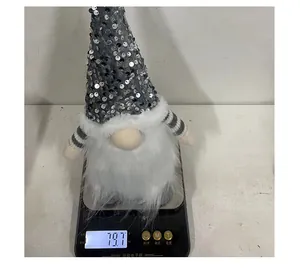 Detailed view of Christmas sequin gnome plush doll weight measurement showing 79.7 grams on scale