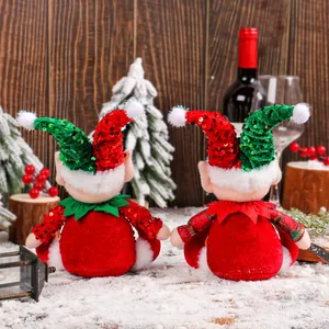 Cute Christmas elf sitting dolls with festive sequin hats for holiday window display