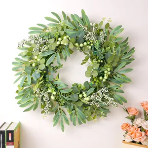 Realistic artificial eucalyptus and green berry wreath for front door home decoration.