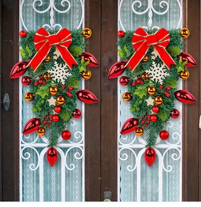 Detailed view of red bow and snowflake on Christmas teardrop swag wreath