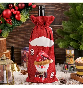 Detailed view of red burlap Christmas wine bottle cover with a cute snowman doll