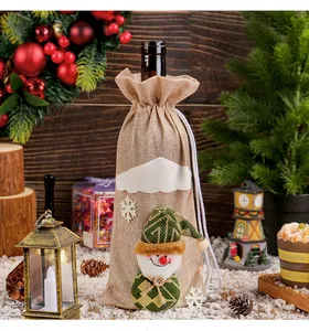 Detail view of a rustic burlap Christmas wine bag featuring a cute snowman character