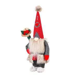 Staande Valentijnskabouter van pluche met een roos van jute op een witte achtergrond