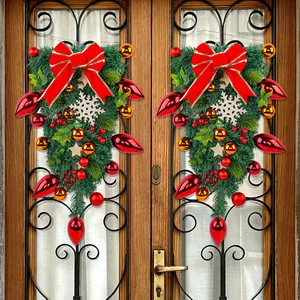 Festive Christmas teardrop wreaths with red bows and snowflakes hanging on wooden doors