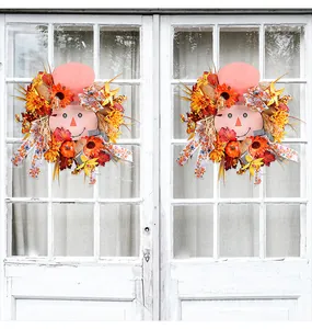 Detailed view of autumn harvest wreath featuring wooden scarecrow face and pumpkin accents