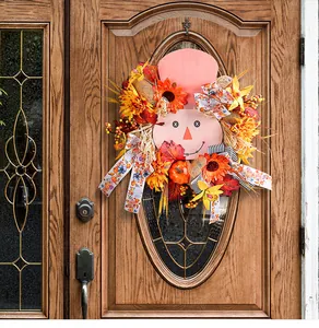 Detail view of the autumn harvest scarecrow wreath featuring sunflowers and pumpkins.