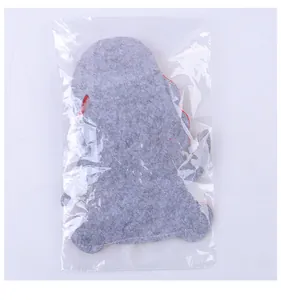 Detailed back view of a Christmas gnome felt cutlery holder inside transparent plastic packaging
