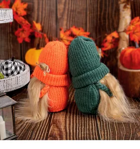 Detailed view of knitted harvest festival gnomes with vibrant orange and green hats