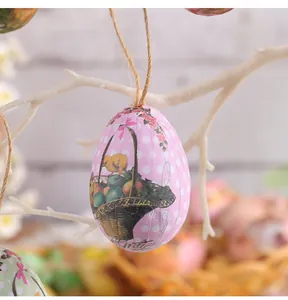 Close-up of a pink foam Easter egg ornament with chick print hanging on white branch