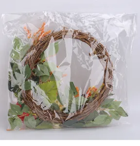 Detailed view of an autumn harvest artificial wreath inside clear protective plastic packaging