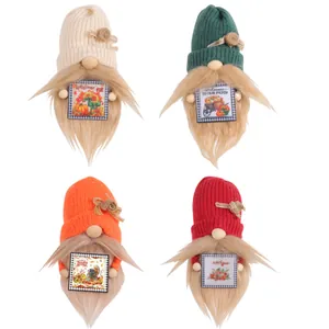 Set of four knitted harvest festival gnomes with autumn signs for tabletop decoration