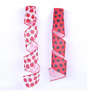 Close-up of red polka dot and ladybug patterned ribbons for gift wrapping