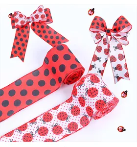 Detailed view of red ladybug and black polka dot decorative ribbons for festive gift wrapping