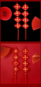 Close-up of traditional red Chinese knot pendants with gold festive greetings and tassels.