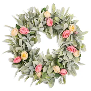 Detailed view of a lush artificial lamb's ear wreath with pink and peach roses.