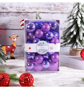 Close-up of mixed purple glitter and shiny Christmas baubles in a rectangular gift box