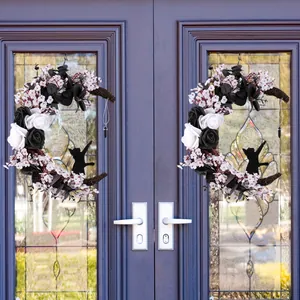 Gothic Halloween moon cat wreath with white flowers and black roses on double doors