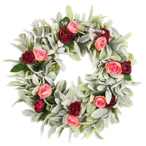 Detailed view of the artificial lamb's ear wreath featuring vibrant red and pink roses