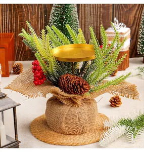 Detailed view of small Christmas candle holder with red berries and pine cones
