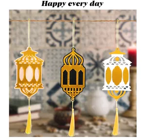 Detailed view of three hanging wooden lantern ornaments with elegant golden tassels.