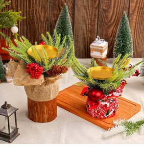 Close-up of small Christmas candle holders with red berries and pine needles