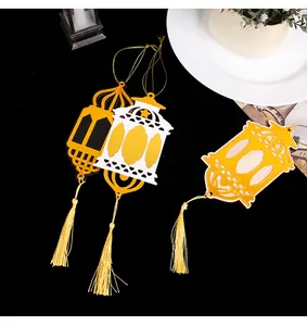 Detailed view of three decorative wooden lantern hangings with golden tassels.