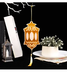 Close-up of an elegant golden wooden lantern hanging ornament with a yellow tassel.
