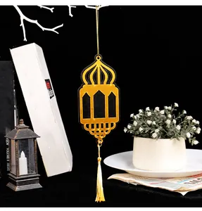 Detail view of gold and black Eid lantern hanging ornament with tassel decoration