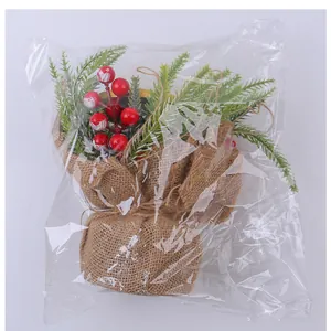 Detailed view of a small Christmas candlestick with red berries inside clear plastic packaging