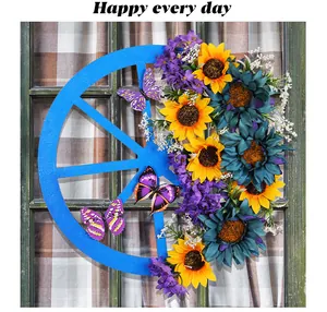Detailed view of artificial blue wagon wheel wreath with yellow and teal sunflowers and butterflies.