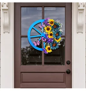 Decorative blue wagon wheel wreath featuring vibrant sunflowers and butterflies on a door