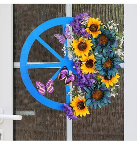 Detail view of blue wooden wheel wreath with vibrant sunflowers and butterflies