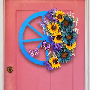 Vibrant blue wagon wheel wreath with sunflowers and butterflies for spring door decoration