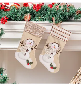 Detailed view of large festive snowman Christmas stockings featuring grid and stripe patterns