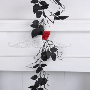 Gothic artificial black Halloween vine with realistic leaves and one red rose.